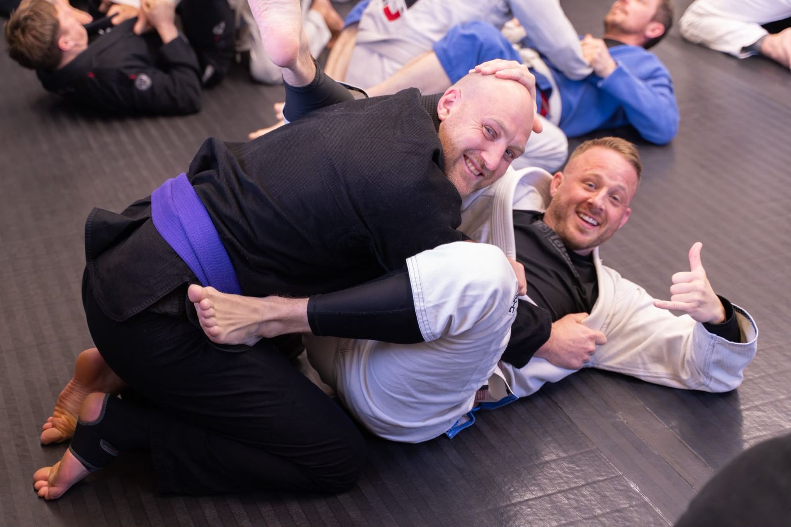Two members smiling mid-roll